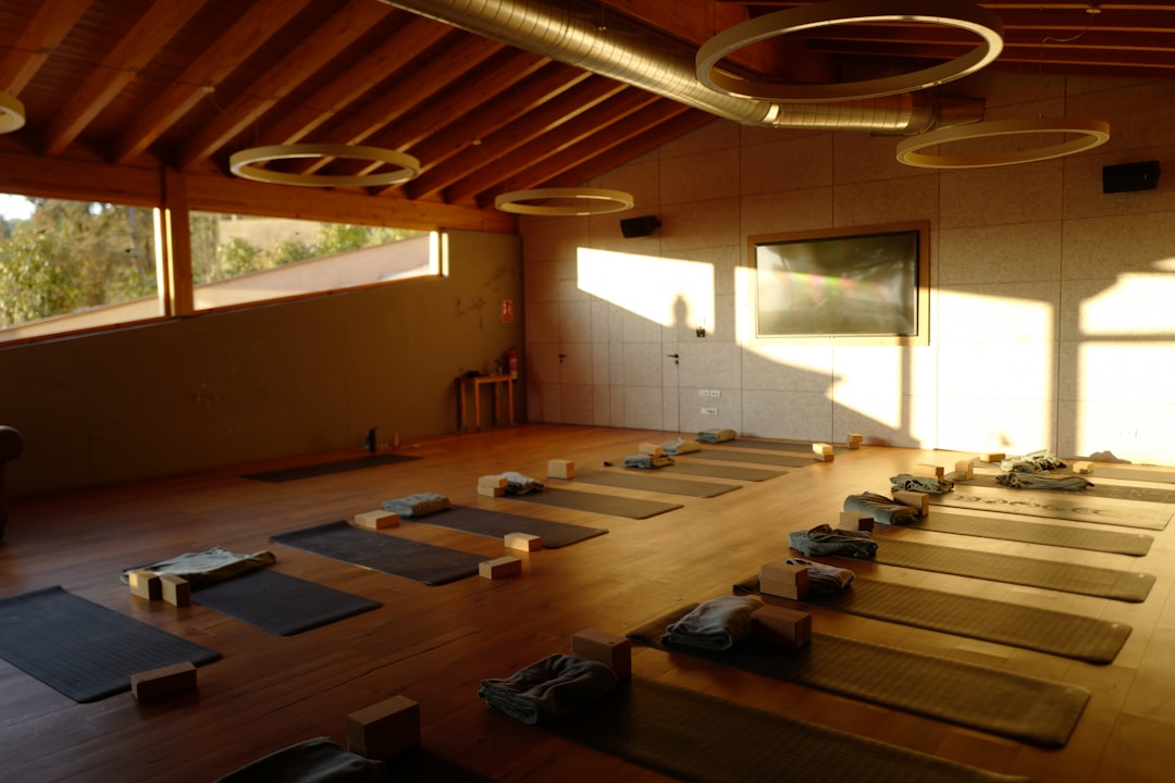 a-large-room-with-a-lot-of-yoga-mats-on-the-floor-dwka5ddrny0